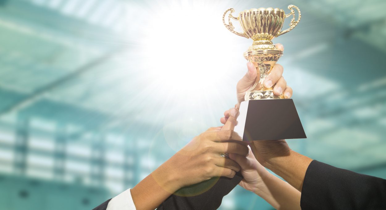 image of hands holding an award trophy for show their victory.